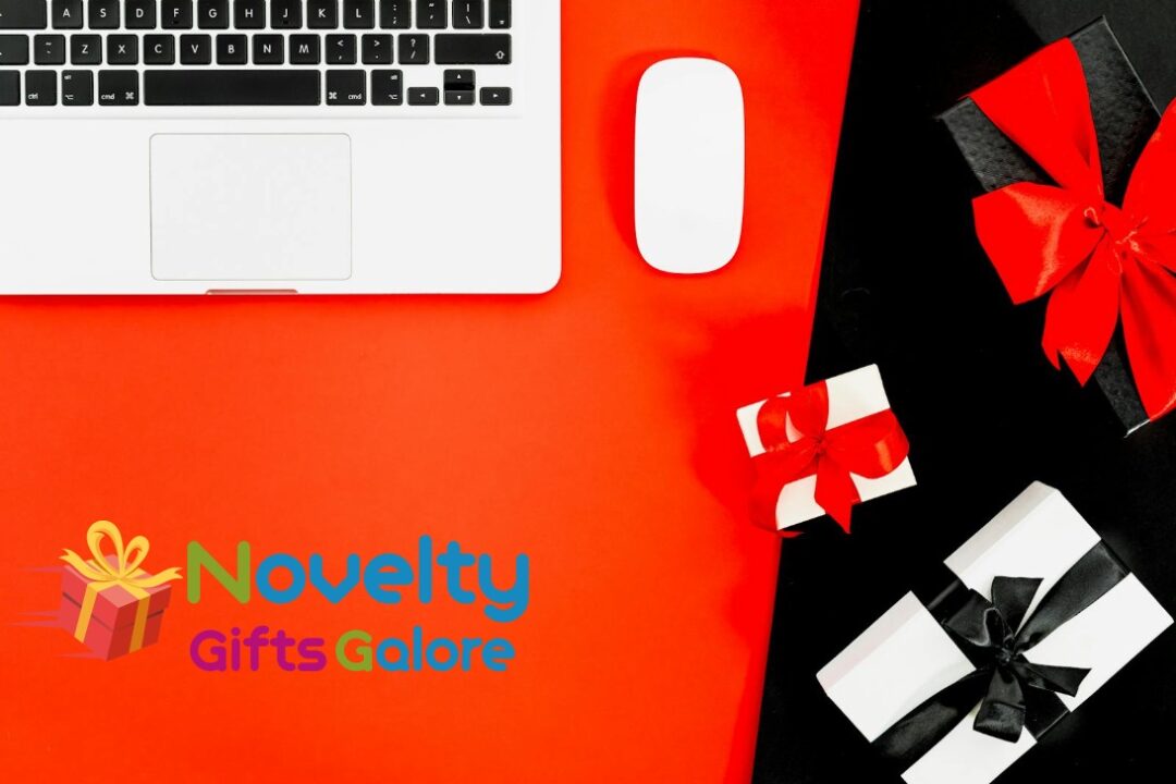 Flat lay of laptop with gift boxes on red background, perfect for holiday shopping themes.